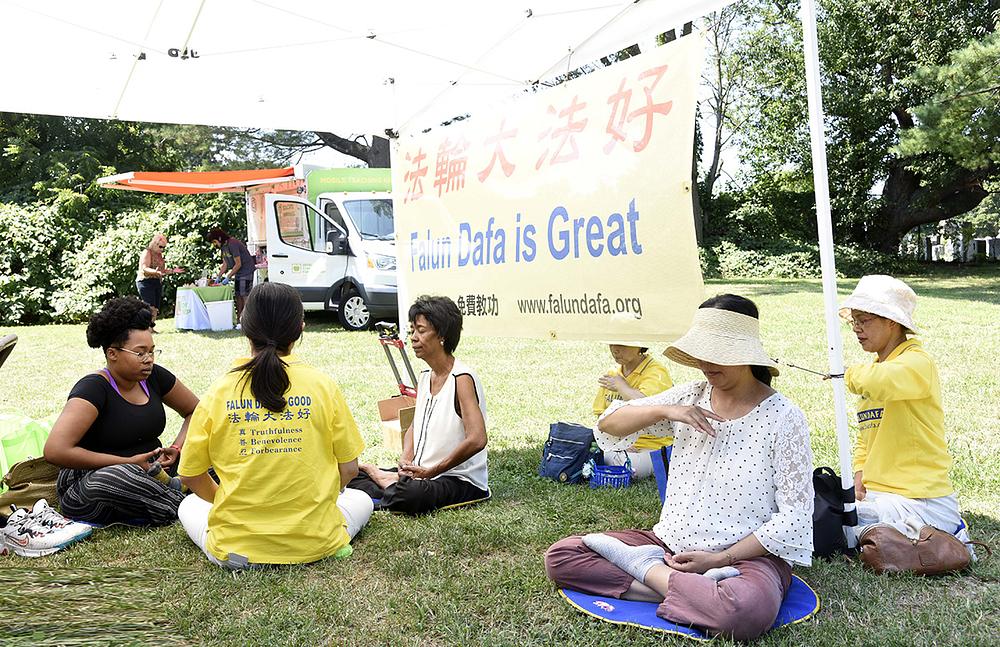 Wanda Lowe (treća slijeva) i Elizabeth (prva slijeva) uče Falun Dafa sjedeću meditaciju.