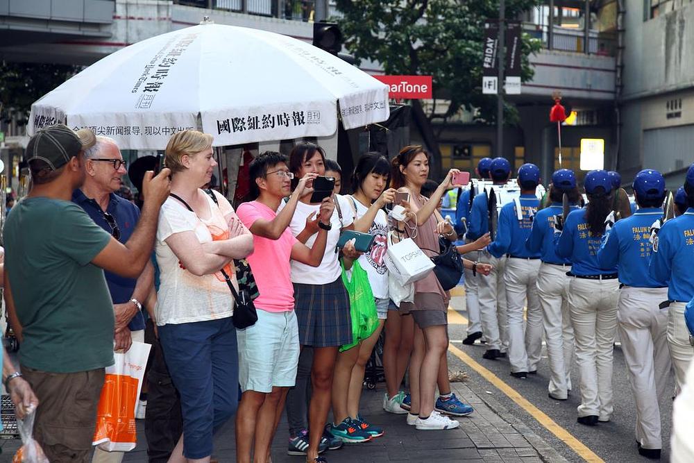 Ljudi gledaju izvedbu Divine Land Marching Band.