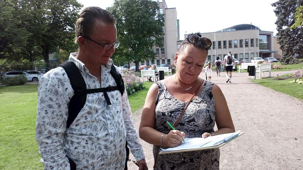 Jedna prolaznica potpisuje peticiju protiv progona.