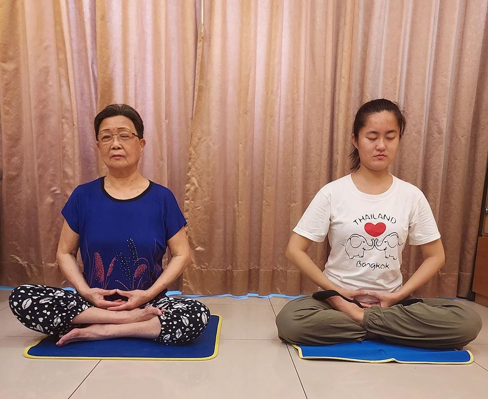 Gđa Liang Qingyu (desno) i njena baka izvode Falun Gong vježbe. 